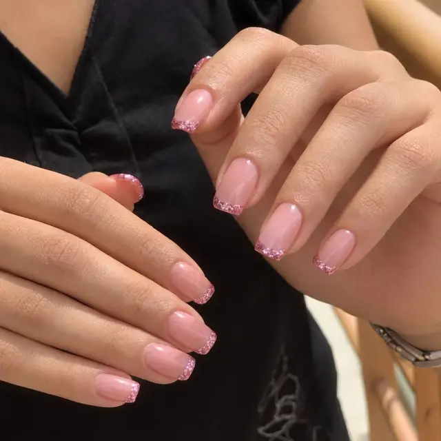 Close-up of pink glitter nails